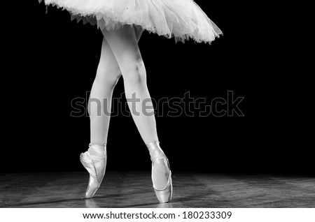 Young female ballerina standing on toes, close up shot of legs