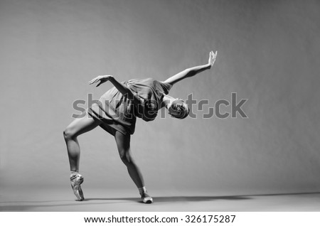 Beautiful modern ballet dancer on tiptoe posing in studio. Extreme flexibility.