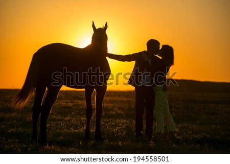 man and woman near a horse