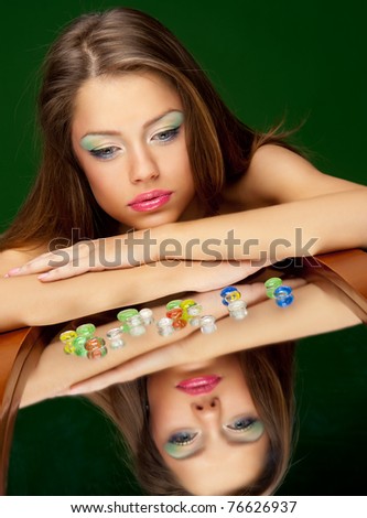 young brunette girl lying on the mirror
