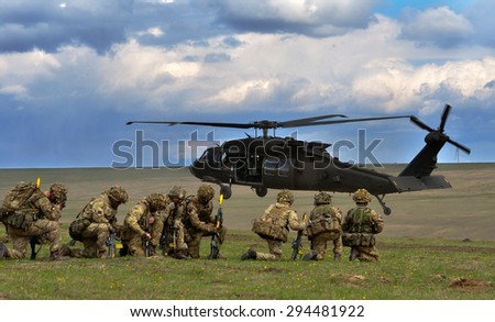 GALATI, ROMANIA - APRIL 22: UK military with semiautomatic rifle wait to board the Black Hawk helicopter in military polygon in the exercise Wind Spring 15 on Galati, Romania, 22 april 2015.
