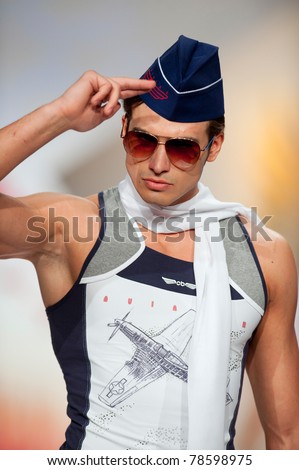 BUCHAREST, ROMANIA - MAY 7: Fashion model wears clothes made by Catalin Botezatu, Aviator collection, in Bucharest Fashion Week at World Trade Center on May 7, 2011, Bucharest, Romania