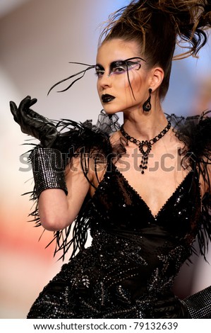 BUCHAREST, ROMANIA - MAY 7: Fashion model wears clothes made by Catalin Botezatu, Black Gold collection, in Bucharest Fashion Week at World Trade Center on May 7, 2011, Bucharest, Romania
