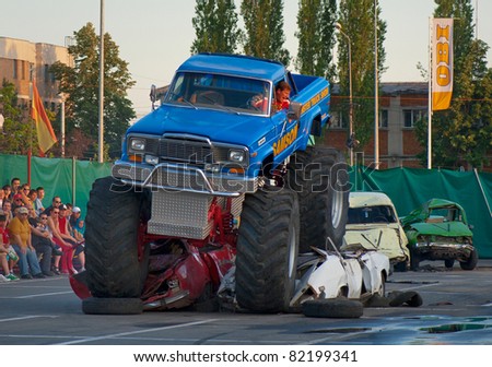 BUCHAREST, ROMANIA - MAY 29: Unknown driver entertains the crowds in his monster truck at \'\'Stunt Cars Show\'\' on May 29, 2011 in Bucharest, Romania