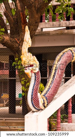 Serpent sculpture on the way up the stairs of the temple in Thailand.