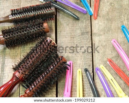 Hair brush comb and Hairpins on wooden background