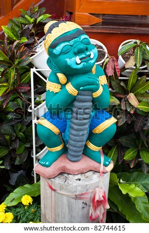 Green Giant statue body. Close your eyes standing in front of the flower garden