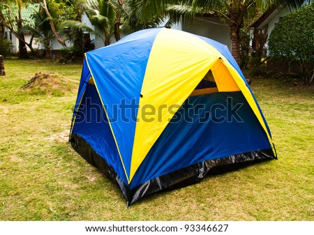 A small canvas tent is placed on the lawn at the resort.
