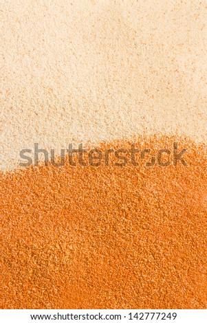 Close up sand background. Texture of white and yellow sands.