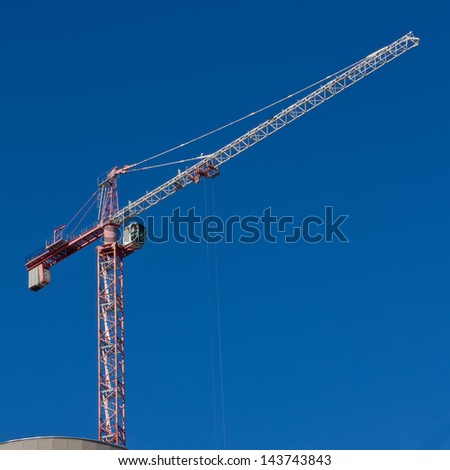 The lifting crane against blue sky