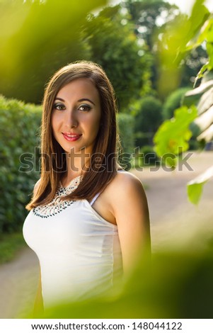 A portrait of a beautiful girl in a park. Image has a lot of space for your own text