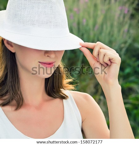 Young woman wearing white hat