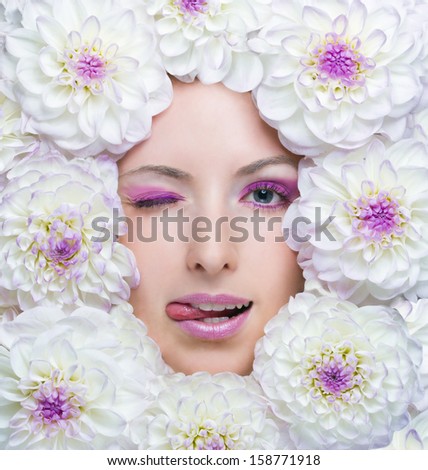 Beauty girl with white flowers around her face. Dahlia flowers. Beautiful makeup. Beauty concept