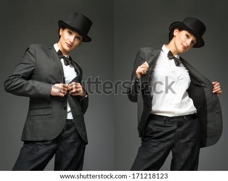 Young woman wearing man\'s suit posing over grey background. Woman feels like a man - concept. Retro style young woman against grey background.