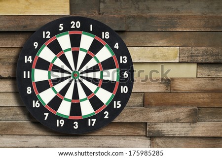 Darts board on a vintage wooden wall with copy space