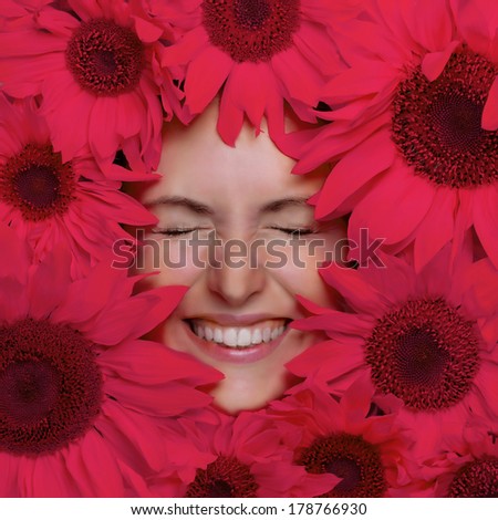 Happy young woman with flowers. Woman face and pink flowers