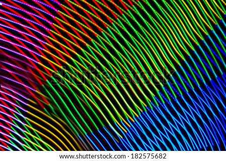 Abstract background made of magic LED lights. Abstract curved lines made by light painting.