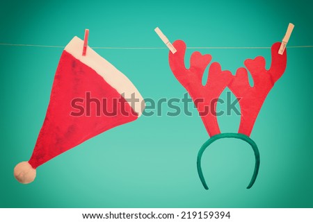 Santa hat and antler of deer on a clothesline. Toned image