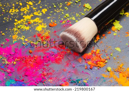 Close-up of a makeup brush  with colorful powder. Beauty concept