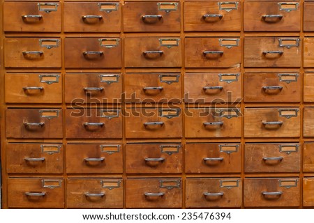 Drawers with blank tags in vintage furniture module