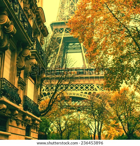 Autumn in Paris. Eiffel Tower between city buildings. Vintage style image