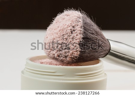 Closeup of makeup brush with powder