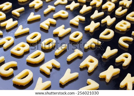 Closeup of alphabet cookie on baking tray