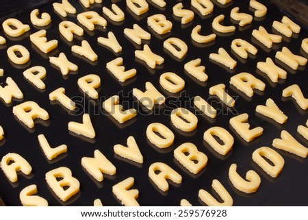 Alphabet cookie on black baking tray