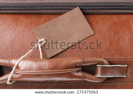 Blank vintage leather tag on a handle of leather business travel case