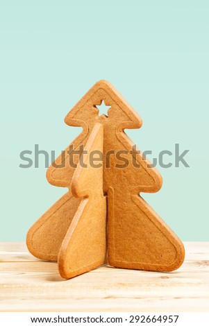 Decorated Christmas cookie shaped like a Christmas tree on wooden table