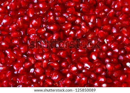 Red ripe seeds pomegranate background.