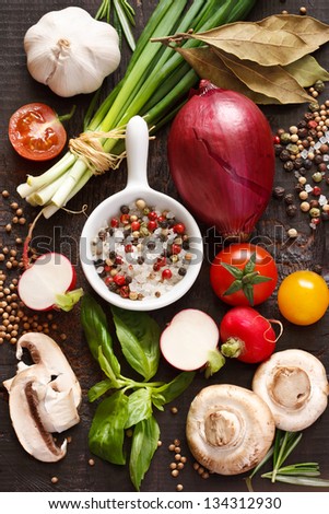 Ingredients for preparing dinner. Fresh vegetables and spices on a wooden background.