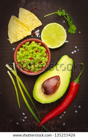 Ingredients For Guacamole And Guacamole Dip On A Dark Background.