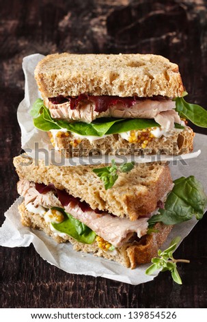 Delicious Sandwich With Meat, Vegetables And Mustard On A Wooden Background.