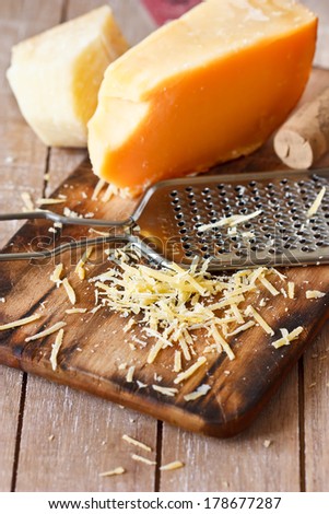 Grated parmesan cheese with a grater close-up.