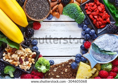 Superfood. Frame of healthy vegan ingredients on white wooden board. Healthy food concept.