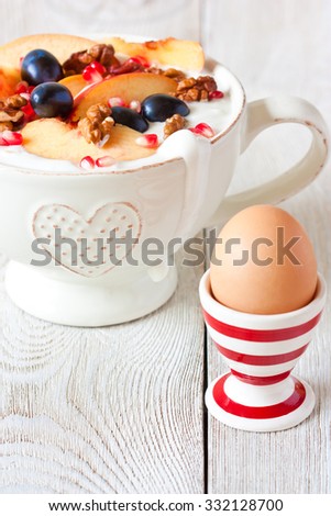 Healthy breakfast. Homemade yogurt with fresh fruit and boiled egg in egg cup.