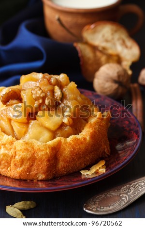 Delicious caramel apple cake with nuts on a plate.