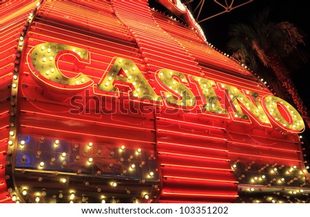 Yellow and red neon lights surround casino sign