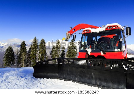 Snow-grooming machine on snow hill ready for skiing slope preparations in Russian Krasnaya Polyana