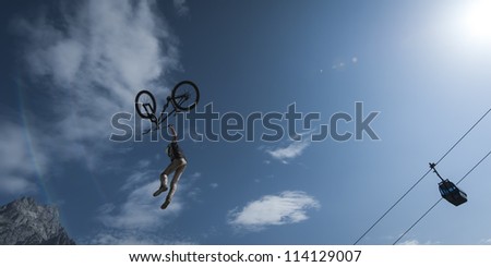 young dirt biker looses control over his bicycle while his stunt high in the air