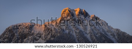 red lighted peak of austrian mountain at sunset in winter