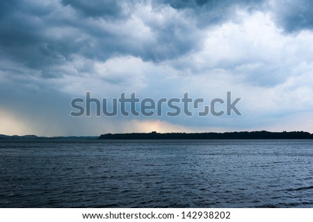 lake chiemsee with heavy weather rain clouds