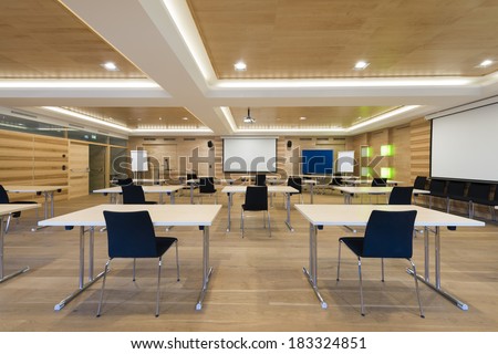 view to projector screen in wooden conference room