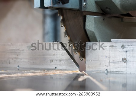 detail of fixed  circular buzz miter saw blade and table