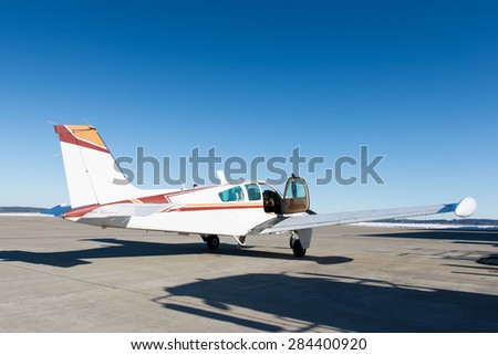 opened door of small propeller-driven aircraft at airstrip