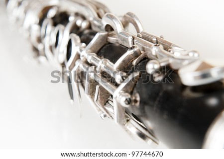 black music clarinet decorated with silver metal on white background