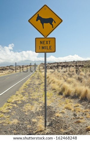 Caution sign, feral donkeys crossing the Hawaiian highway at Kona