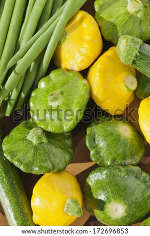 Group of yellow and green pattypan squashes with string green beans, fresh vegetables concept image