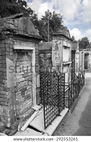 Row of crumbling brick tombs in New Orleans with black & white filter effect
